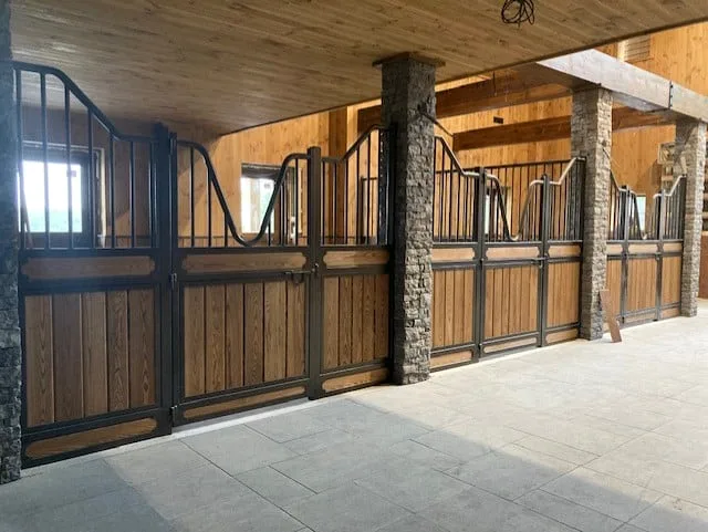 Installation complète de box pour chevaux avec façades en bois et métal